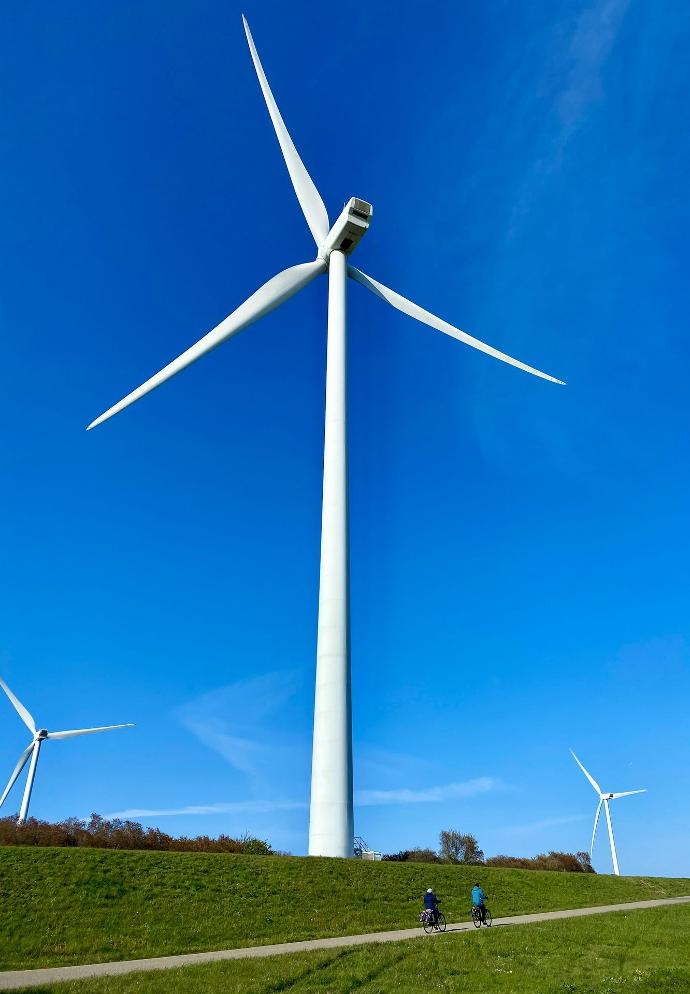 white wind turbine under blue sky during daytime